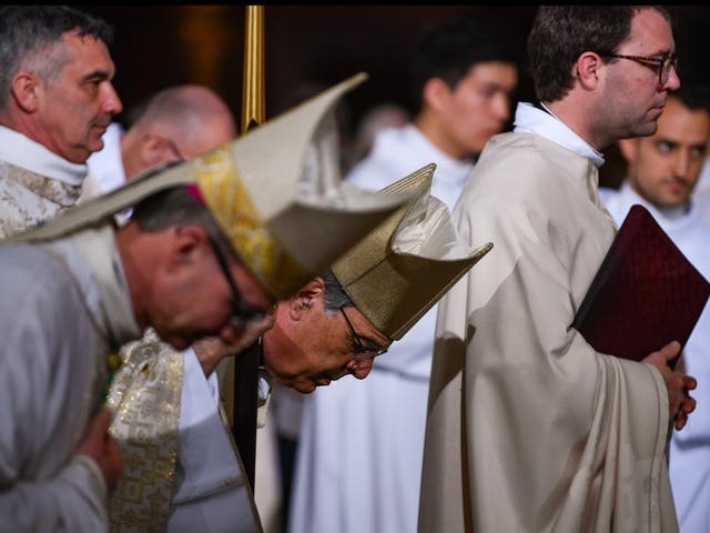 Archbishop Michel Aupetit (C) leads Notre Dame Easter Mass at the church of St Eustache on April 21, 2019 in Paris, France. Notre Dame's Easter service is being held at the nearby St. Eustache church following Monday's devastating fire that caused extensive damage to the historic landmark.