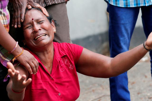 A relative of a victim of the explosion at St. Anthony's Shrine, Kochchikade church, reacts at the police mortuary in Colombo, Sri Lanka