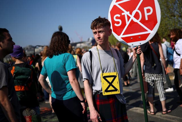 A climate change activist holds a sign during the Extinction Rebellion protest