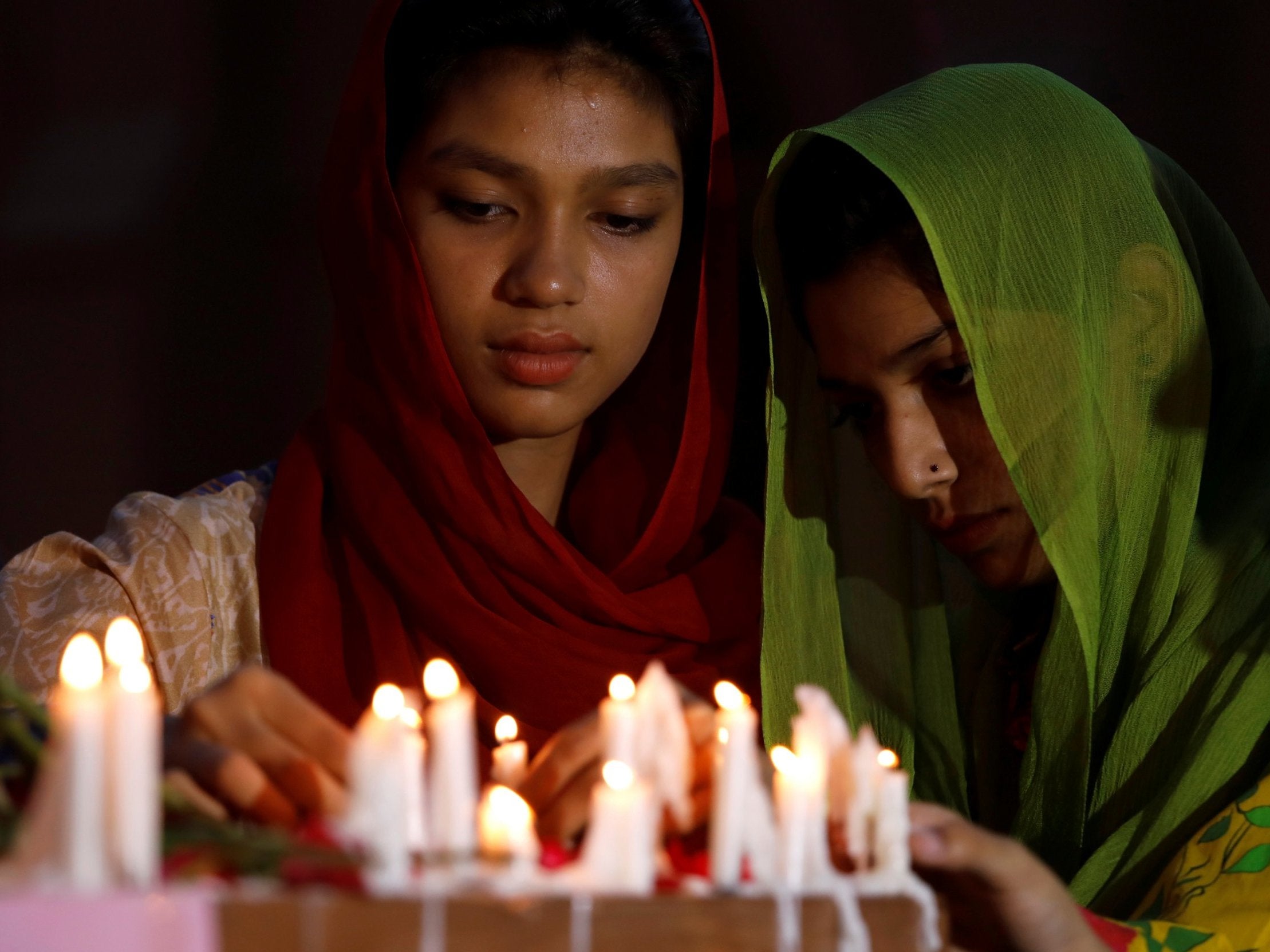 People light candles for the victims of Sri Lanka’s serial bomb blasts, outside a church in Peshawar, Pakistan