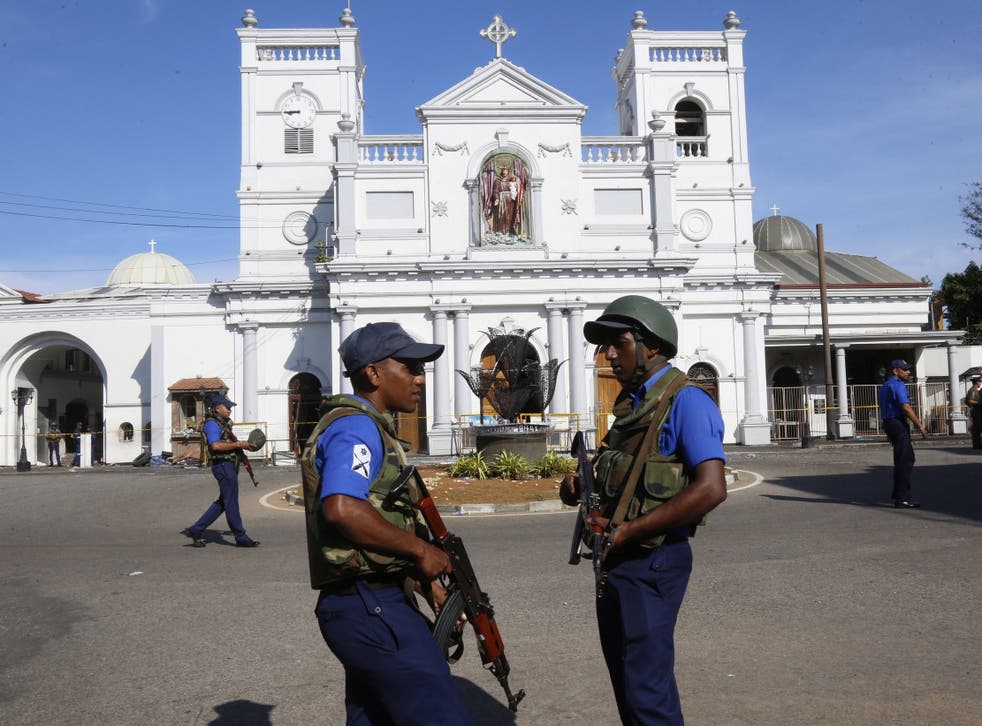Sri Lankan security personal stand guard outside St. Anthony's Church in Kochchikade, Colombo, on Monday