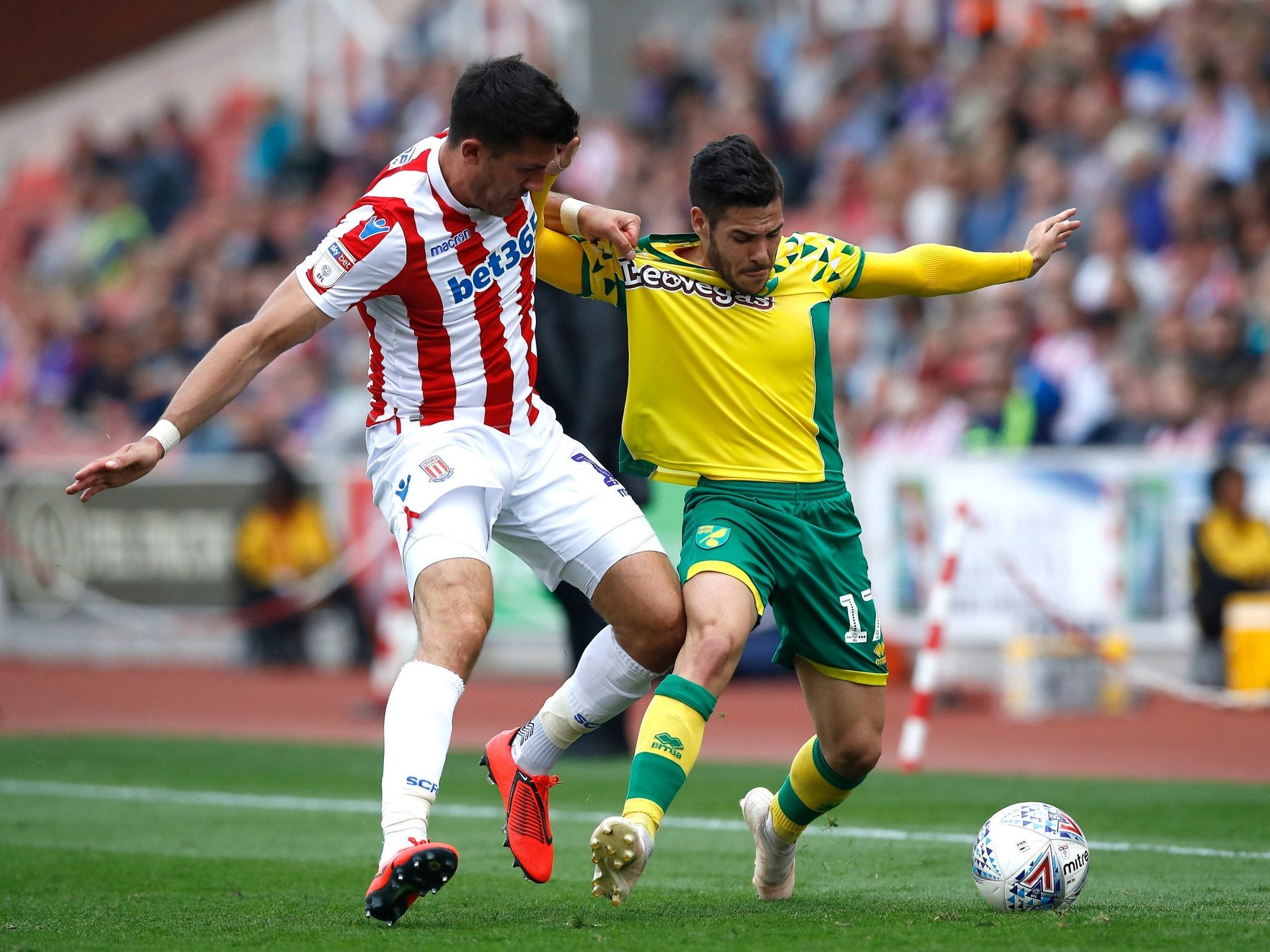 Stoke City’s Danny Batth and Norwich City’s Emi Buendia tussle for possession