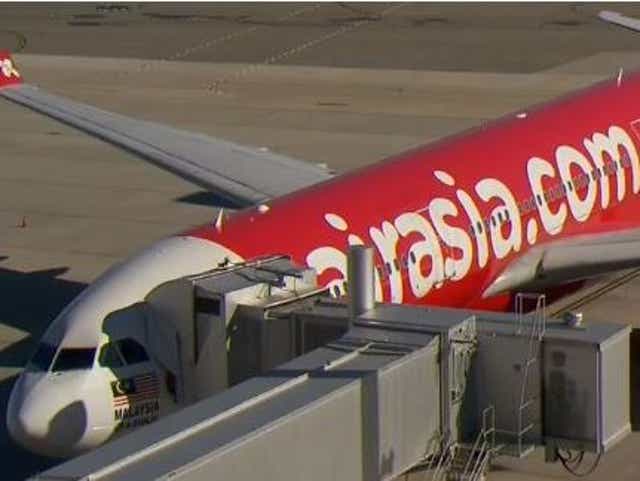 Medical staff and police officers met the Air Asia plane when it landed