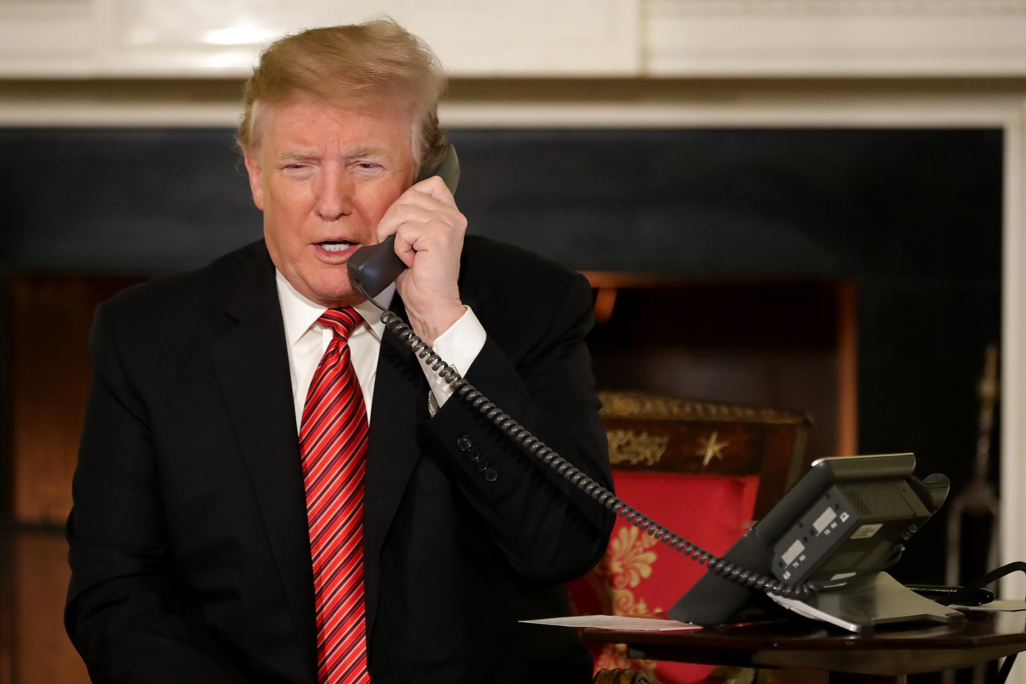 U.S. President Donald Trump takes phone calls from children as he participates in tracking Santa Claus' movements with the North American Aerospace Defense Command (NORAD) Santa Tracker on Christmas Eve in the East Room of the White House December 24, 2018