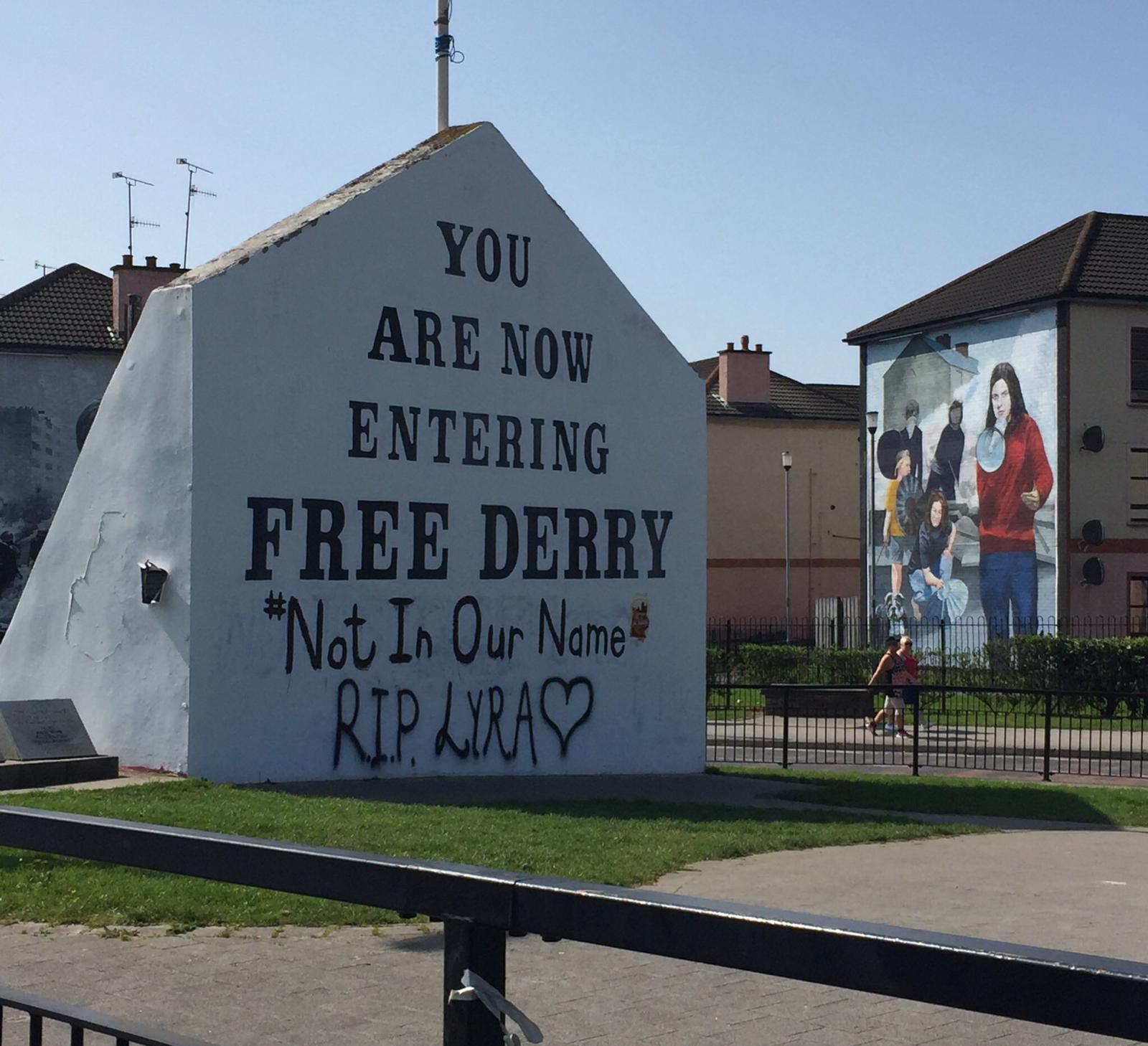 ‘Not In Our Name’ is the message displayed in Lyra’s memory on Free Derry Corner
