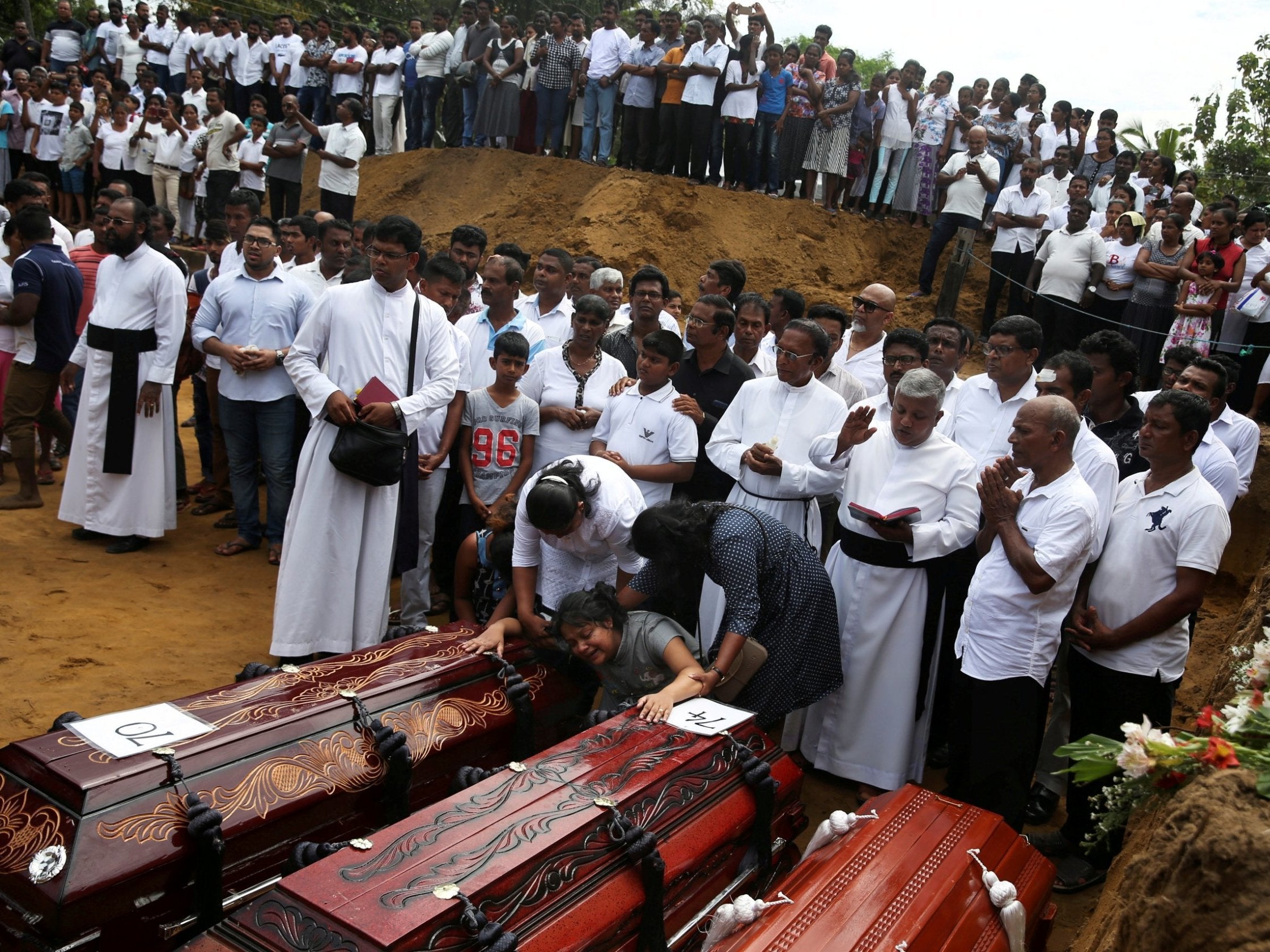 Mass burial of victims at a cemetery near St. Sebastian Church in Negombo, 23 April