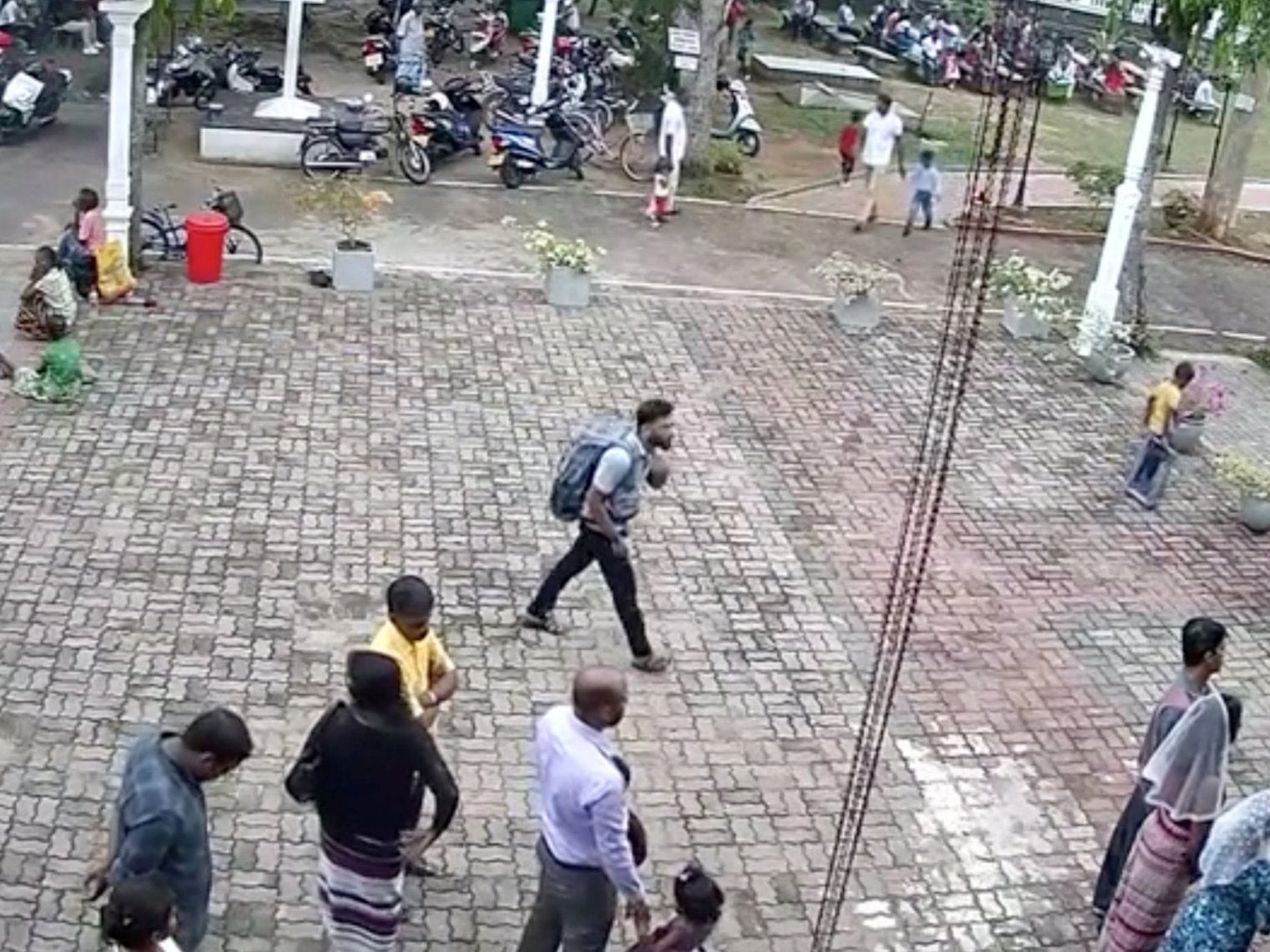Suspected suicide bomber carries backpack outside St. Sebastian's Church in Negombo, Sri Lanka