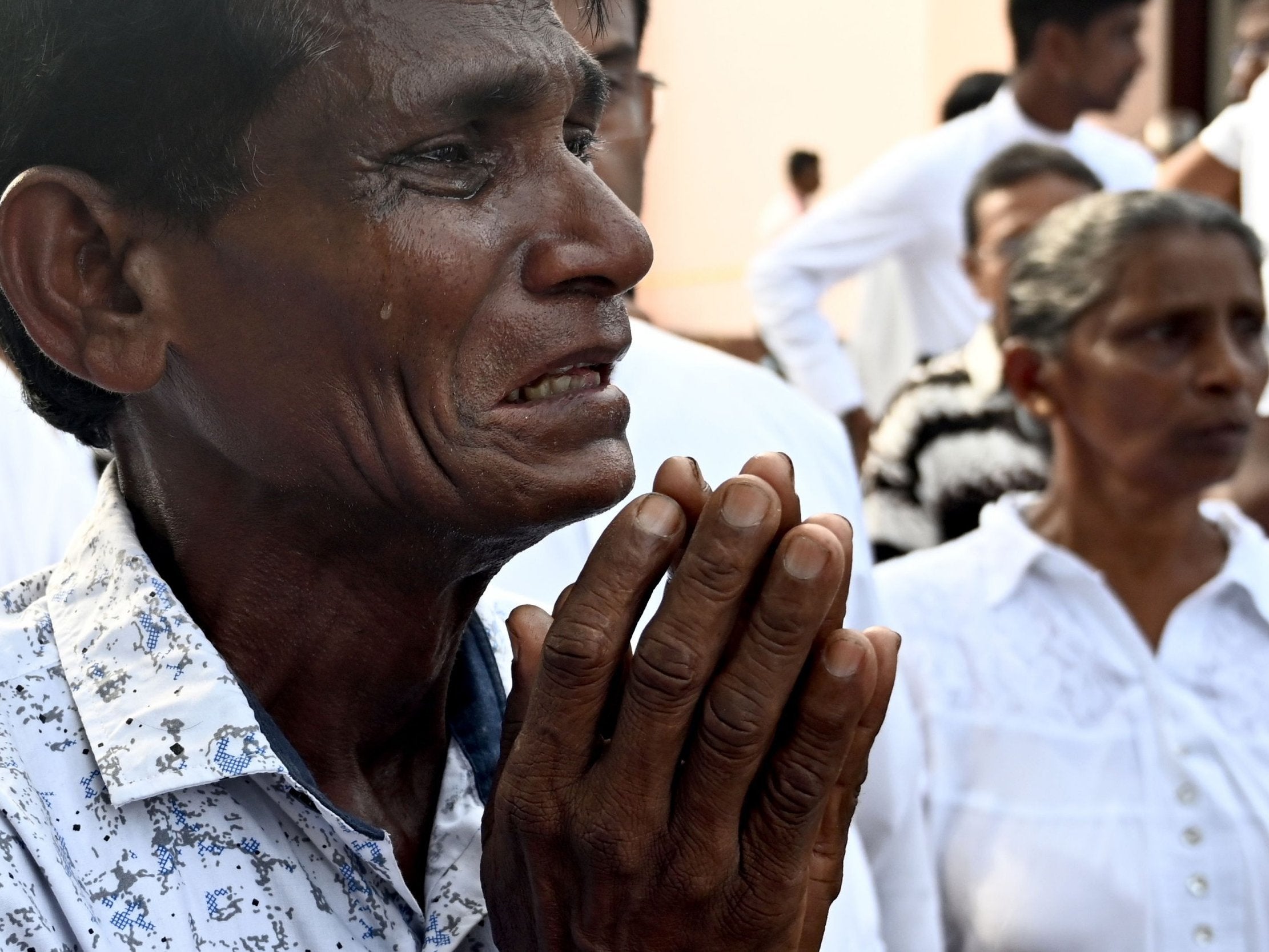 A man weeps during the service for a victim at St Sebastian’s Church yesterday