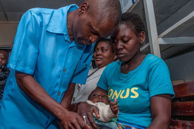 Health worker gives a dose of the malaria vaccine in Malawi's capital Lilongwe