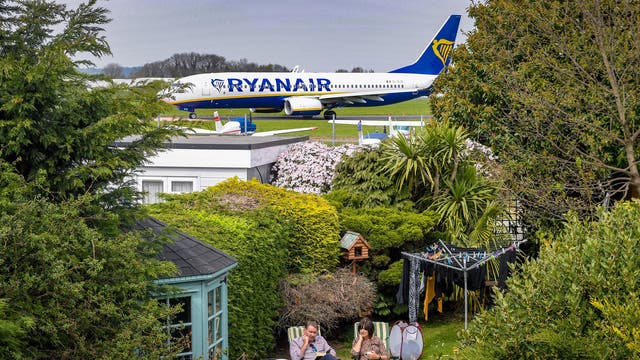 Alex and June Carr in their garden which backs on to Southend Airport in Essex