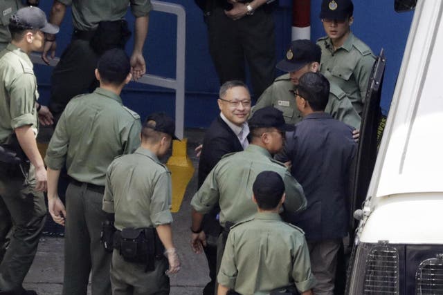 Occupy Central leaders Benny Tai, centre, and Chan Kin-man, right, are escorted by officers at a prison yard in Hong Kong