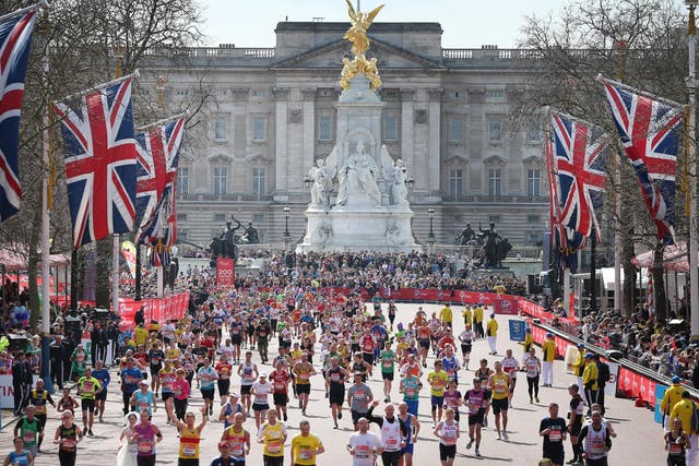 Runners in the London Marathon pass Buckingham Palace as they enter the finishing straight on April 21, 2013 in London, England.