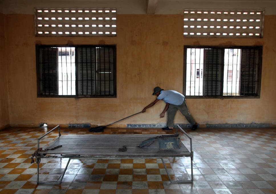 A worker cleans the floor inside the notorious S-21 prison known as Tuol Sleng, which has since been turned into a museum, where more than 15,000 people were executed during the Khmer Rouge regime
