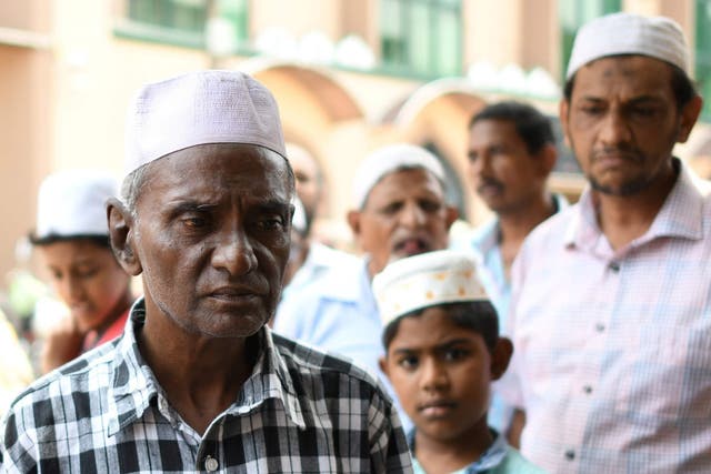 Members of Sri Lanka’s Muslim community gather outside the mosque in Colombo on Tuesday