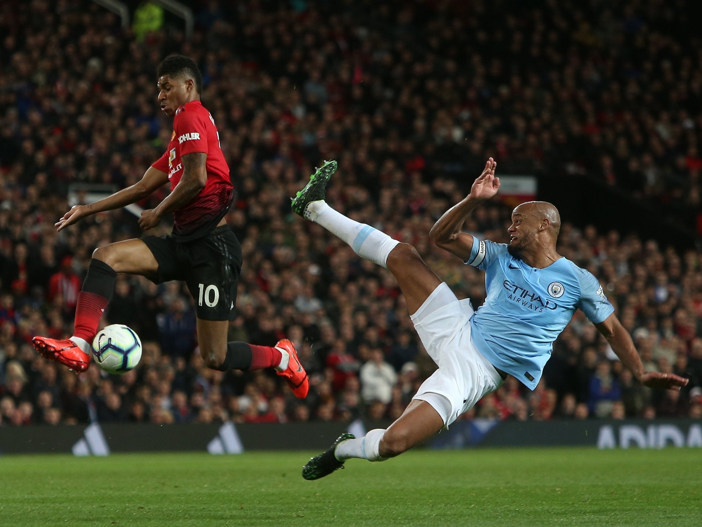 Marcus Rashford tries to get by Vincent Kompany