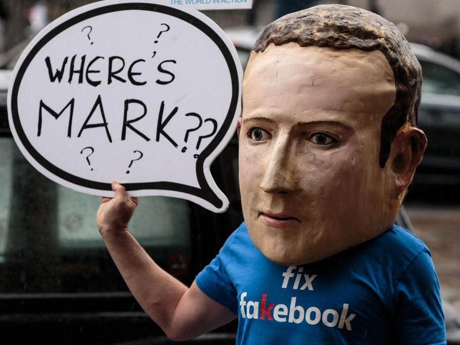 A protester wearing a model head of Facebook CEO Mark Zuckerberg poses for media outside Portcullis House on 27 November, 2018 in London, England