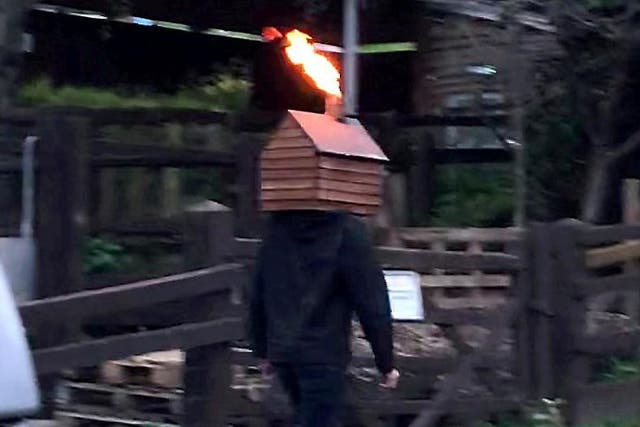 A video taken by Bristol resident Edward Jenkins, 35, shows a man inexplicably strolling along a street with a disco shed blasting fire from the chimney