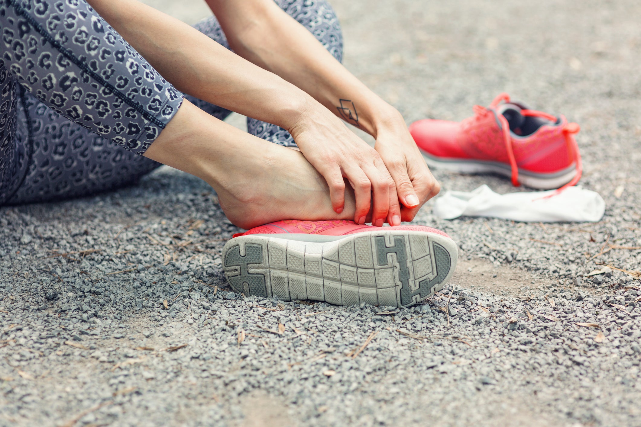 Image of female hands massaging her injured foot