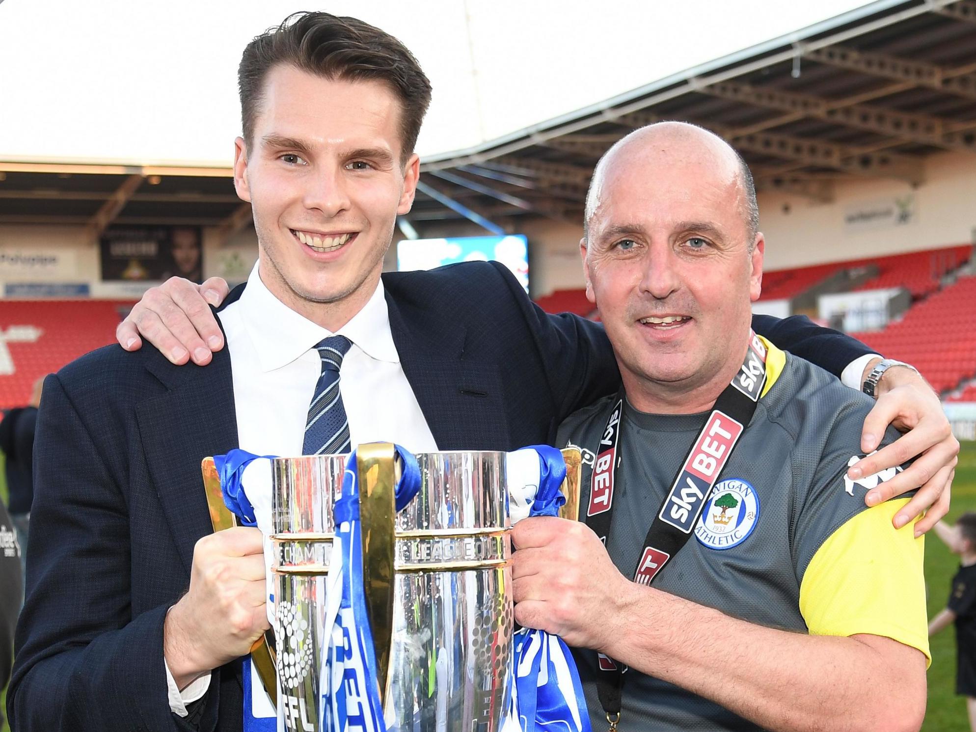 David Sharpe, left, celebrates Wigan’s title win with manager Paul Cook