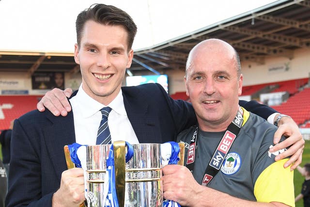 David Sharpe, left, celebrates Wigan’s title win with manager Paul Cook