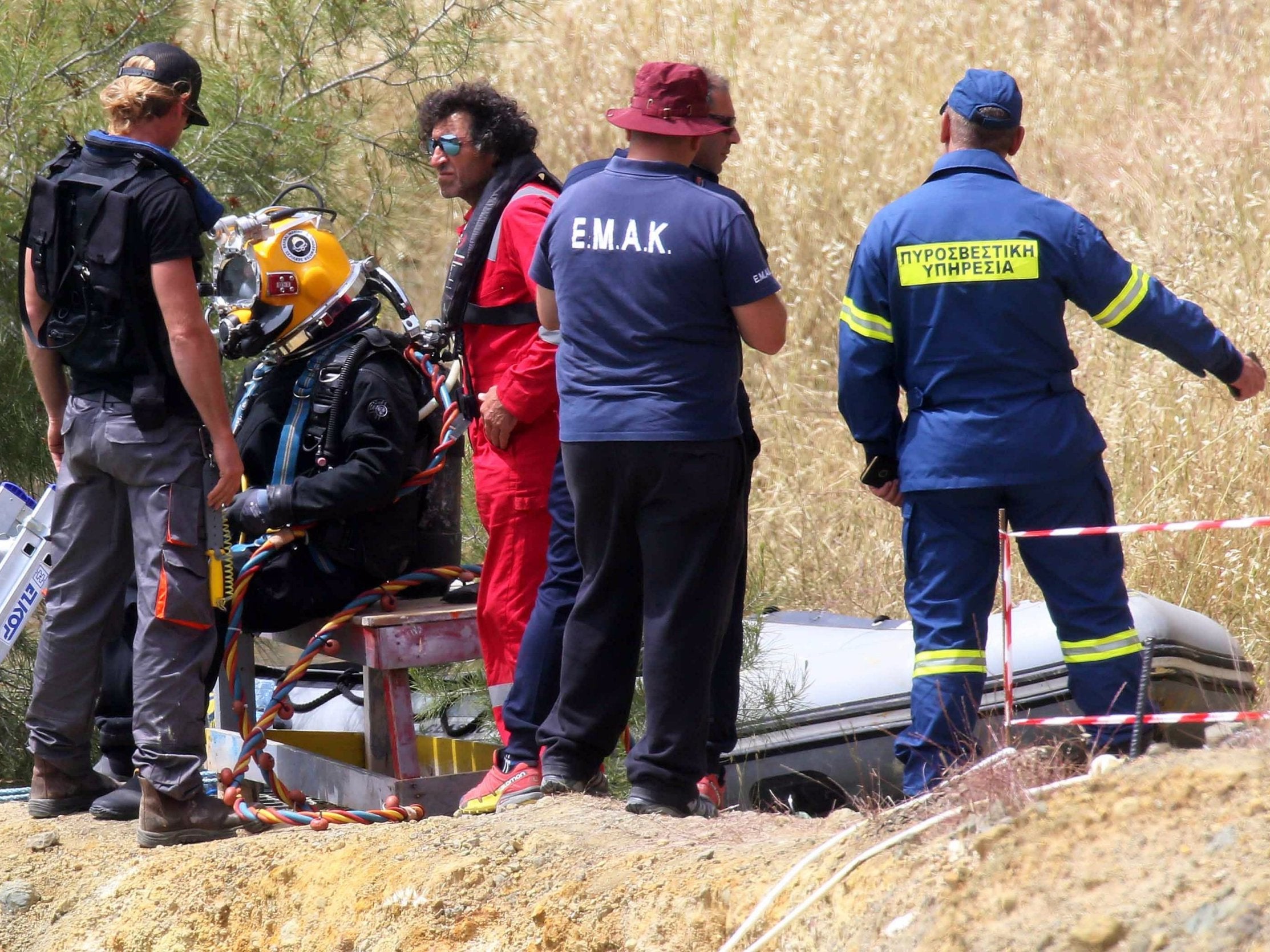 Firefighters and investigators search a lake near the village of Xiliato for the remains of more victims outside Nicosia, Cyprus, 26 April 2019.