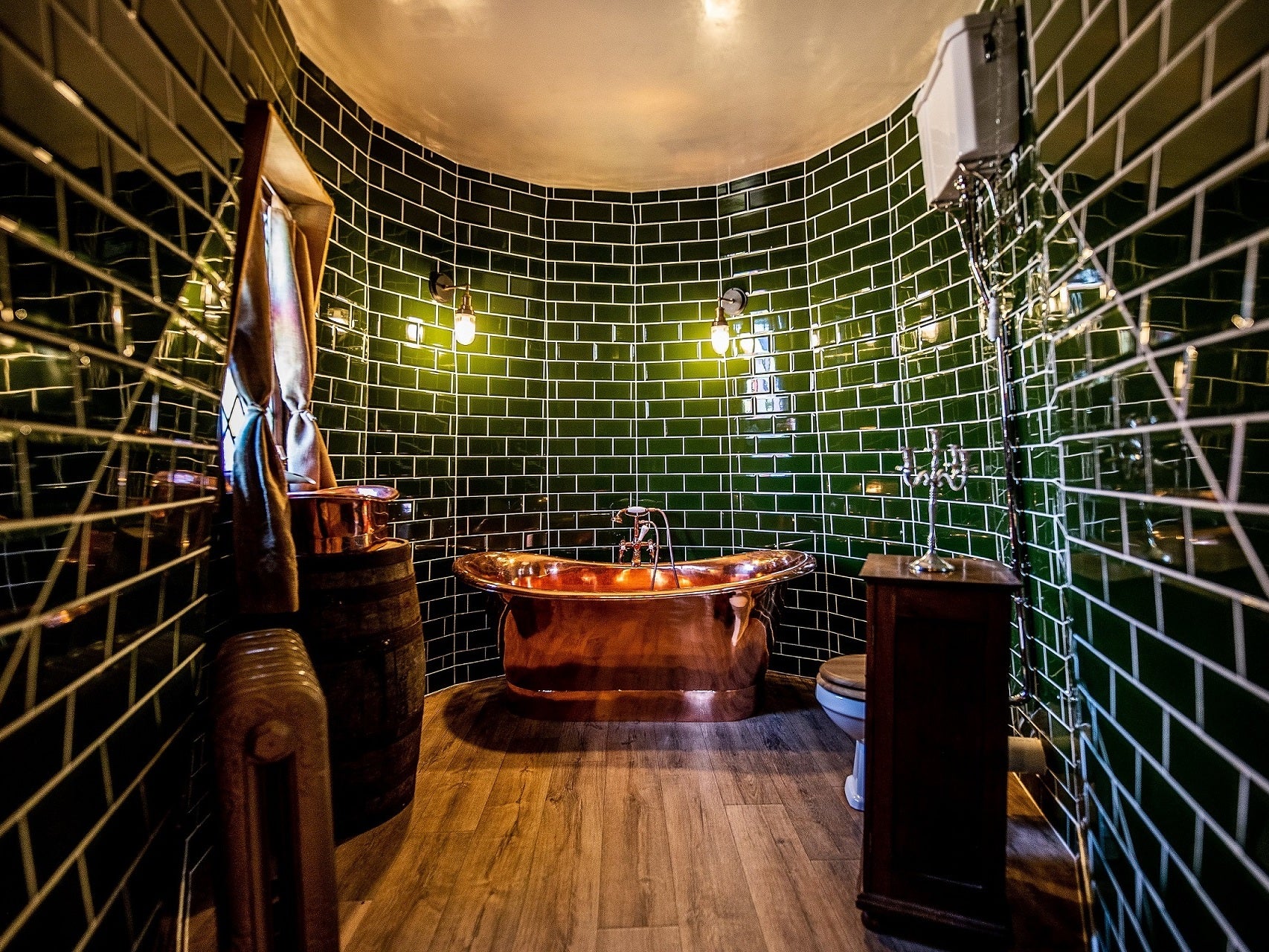 The bathroom is designed with colours reminiscent of the Slytherin Common Room