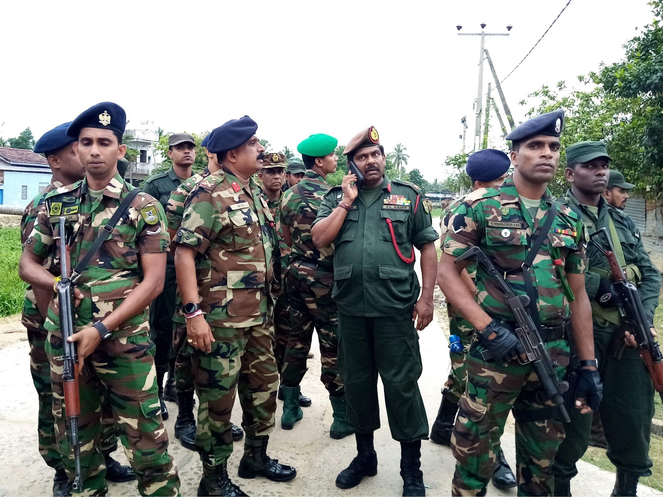 Soldiers stand guard after they raid what is believed to be an Islamist safe house in the eastern town of Kalmunai