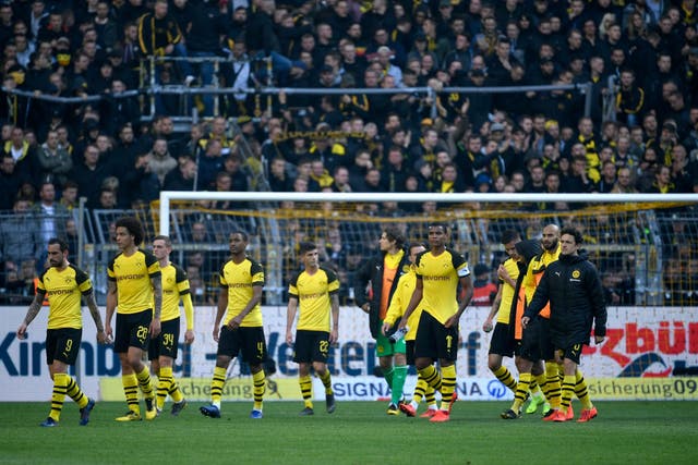 Borussia Dortmund players look crestfallen as rivals Schalke dent their title hopes