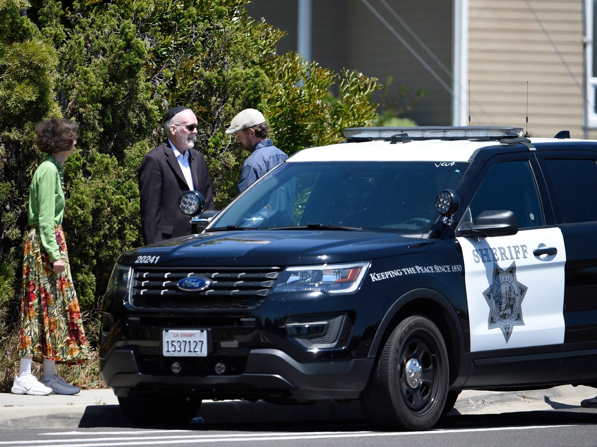 Synagogue members stand outside of the Chabad of Poway Synagogue following shooting