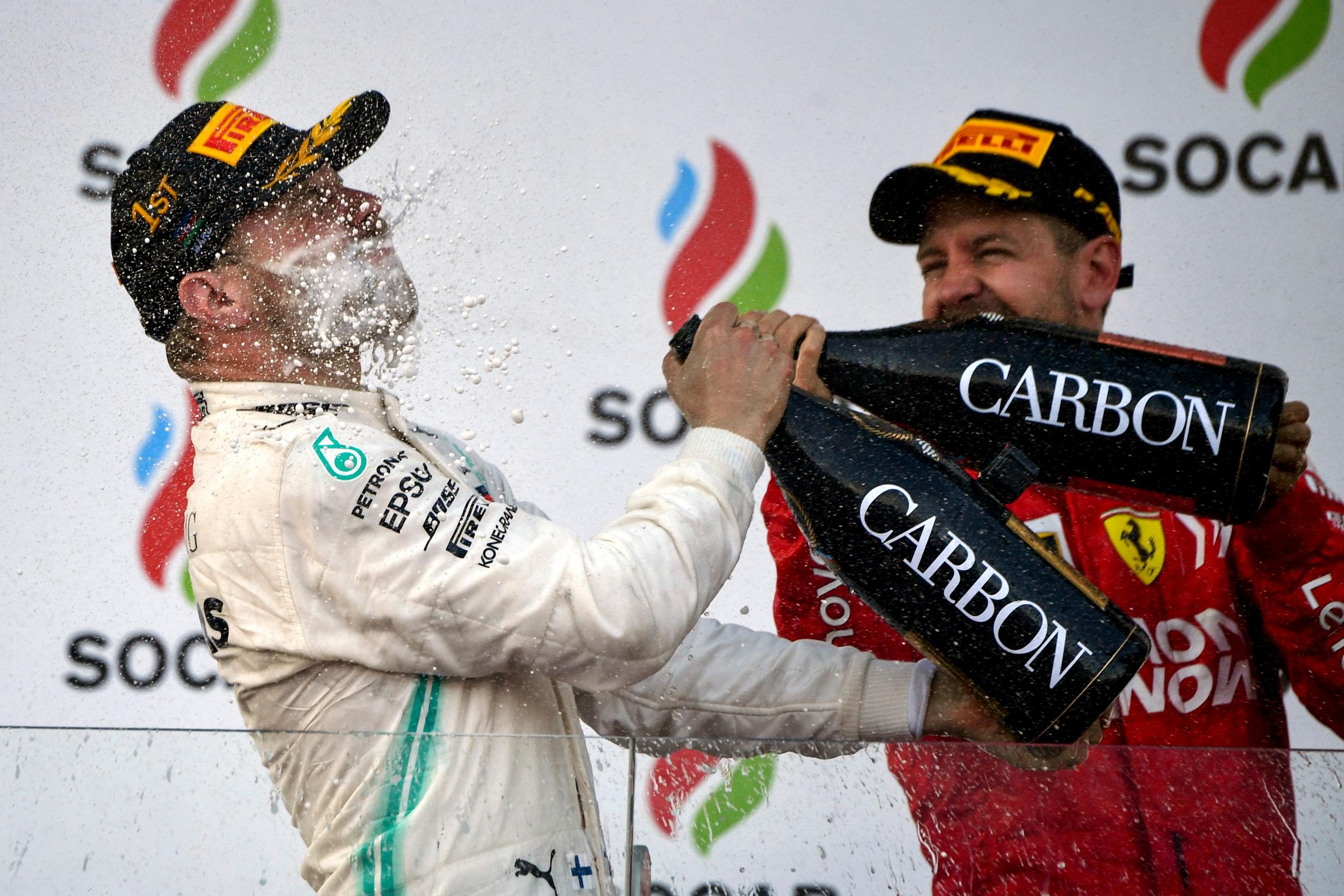 Third-placed Vettel celebrates with race-winner Vettel (AFP/Getty)