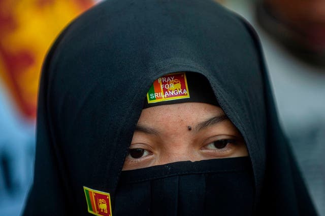 Pictured: A Muslim woman shows solidarity to victims the day after the Sri Lanka blasts on 22 April 2019