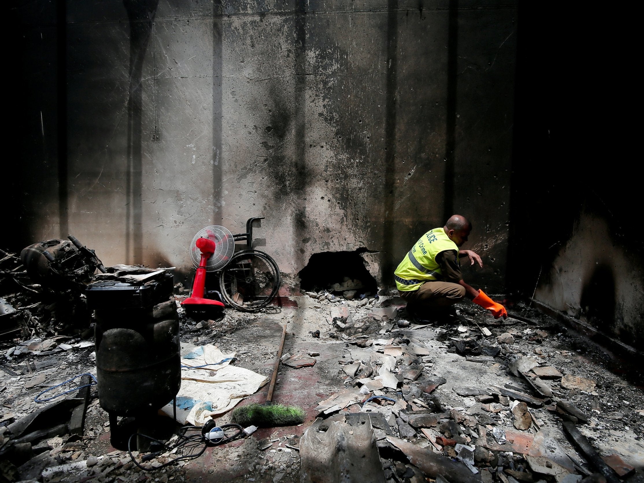 A police officer inspects the site of a gun battle between troops and suspected Islamist militants