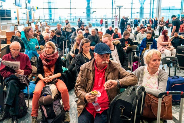 Travellers wait at Gardamoen Airport in Oslo, Norway