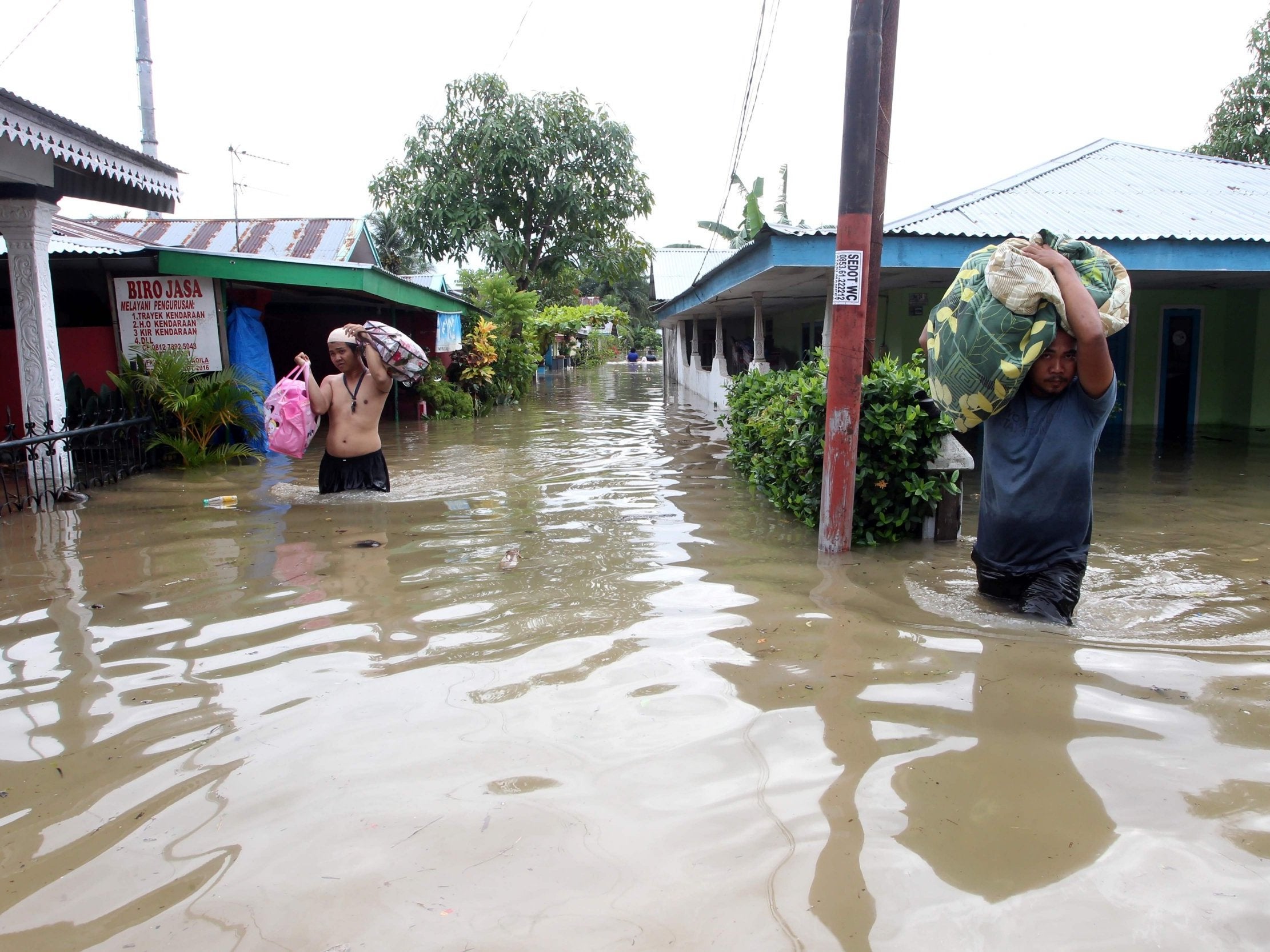 Residents salvage their belongings after their homes in Bengkulu province were flooded (AFP/Getty)