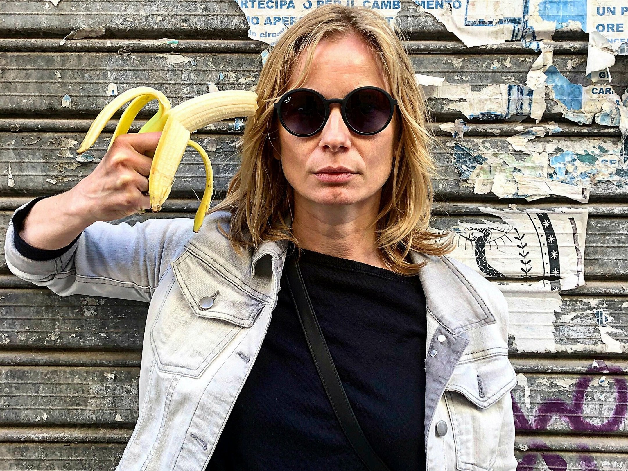 Polish actress Magdalena Cielecka aims a banana like a gun at her head to protest the removal of an artwork from the National Museum in Warsaw