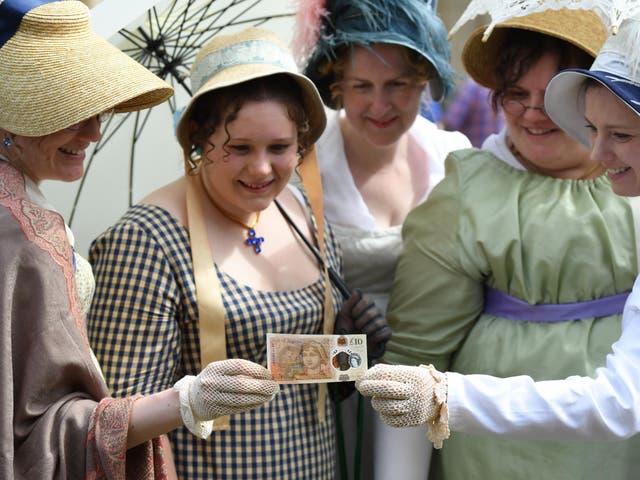 People in period costume celebrate £10 note celebrating Jane Austen