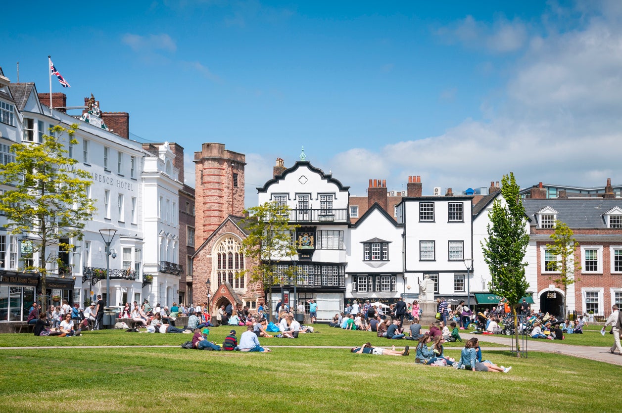 People relaxing on Exeter's cathedral green