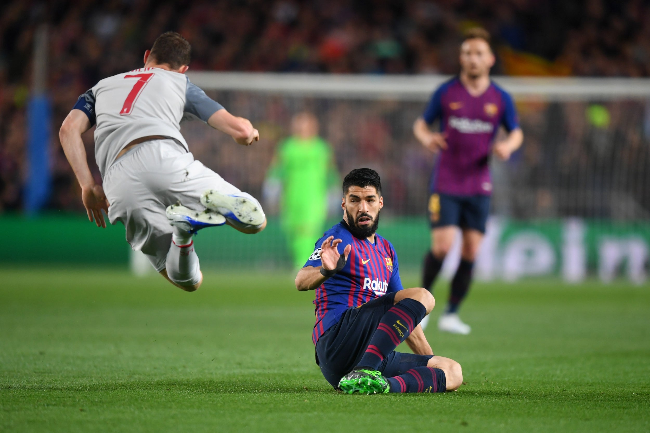 Luis Suarez tackles James Milner