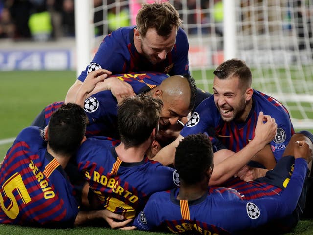 Barcelona players swarm Lionel Messi after his free-kick secured a 3-0 win over Liverpool