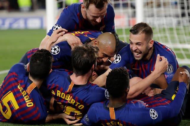 Barcelona players swarm Lionel Messi after his free-kick secured a 3-0 win over Liverpool