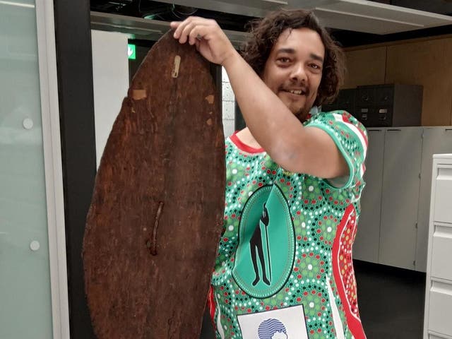 Rodney Kelly poses with his ancestral shield during a private viewing at the British Museum