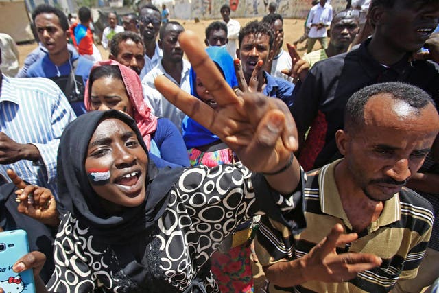 Sudanese chant slogans as they gather during a demonstration outside the army headquarters in Khartoum on Thursday