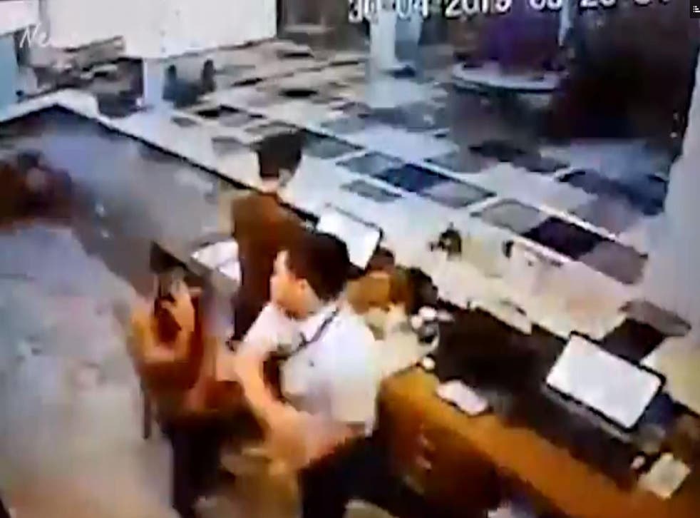 A Lion Air pilot has been suspended following CCTV of him reprimanding a hotel check-in agent