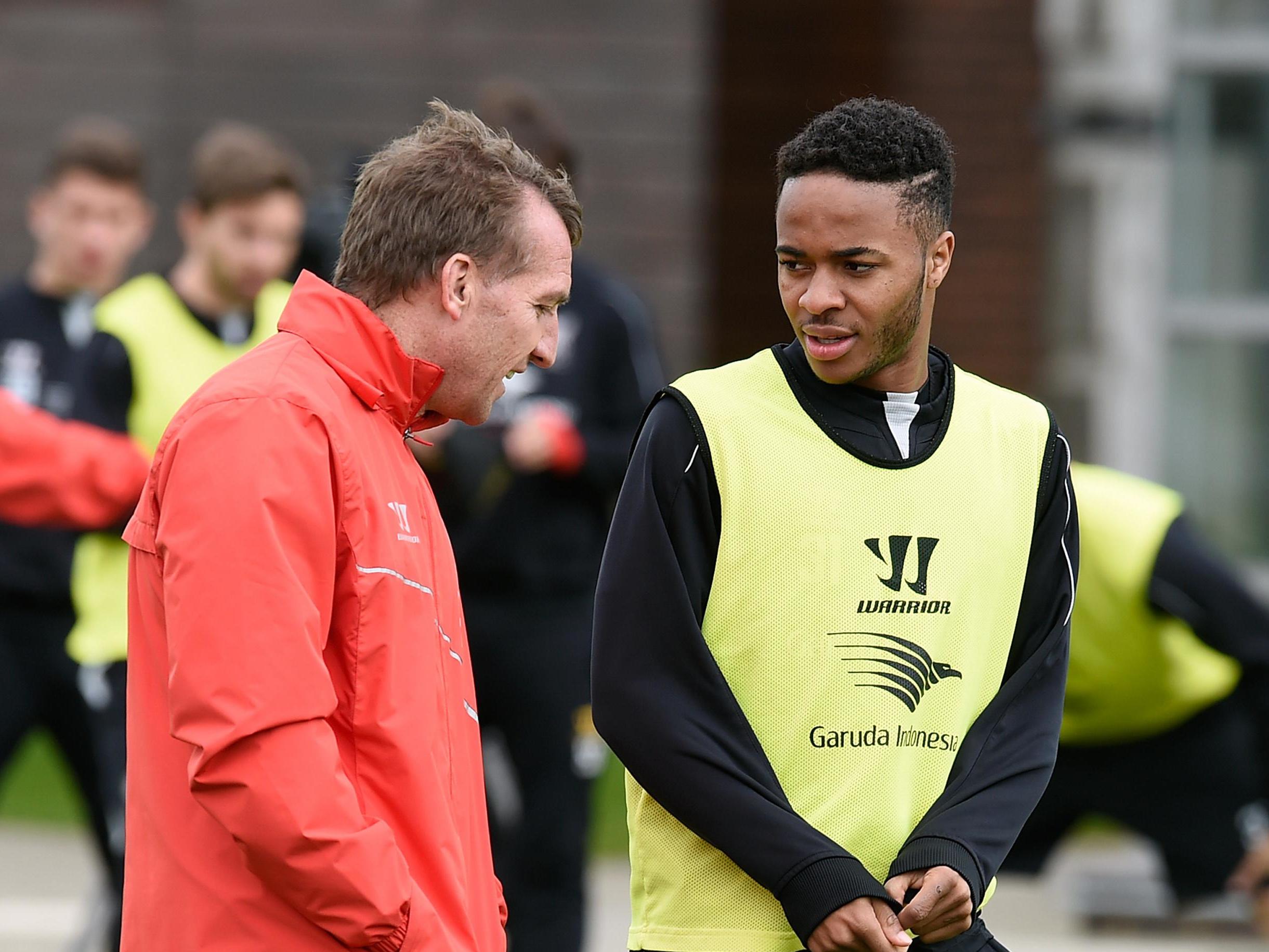 Brendan Rodgers and Raheem Sterling chat during training