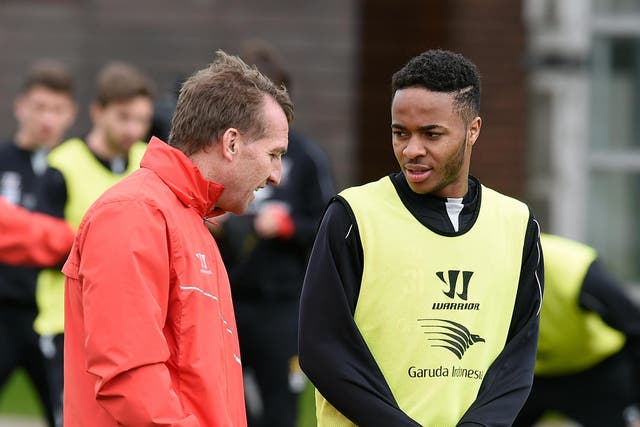 Brendan Rodgers and Raheem Sterling chat during training