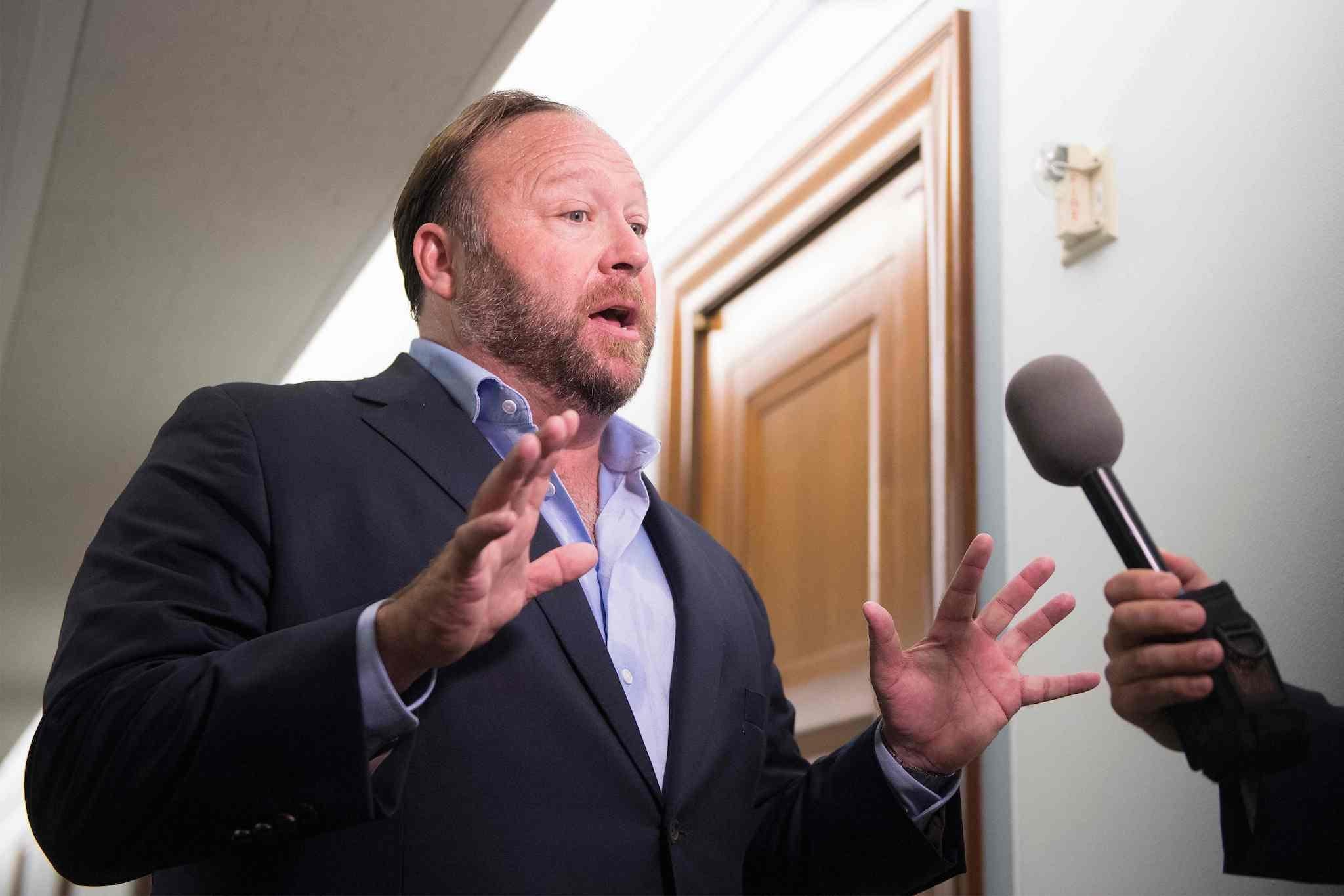 In this file photo taken on September 05, 2018 right-wing conspiracy theorist Alex Jones speaks with reporters outside as Twitter CEO Jack Dorsey and Facebook COO Sheryl Sandberg testify before the Senate Intelligence Committee on Capitol Hill in Washington, DC