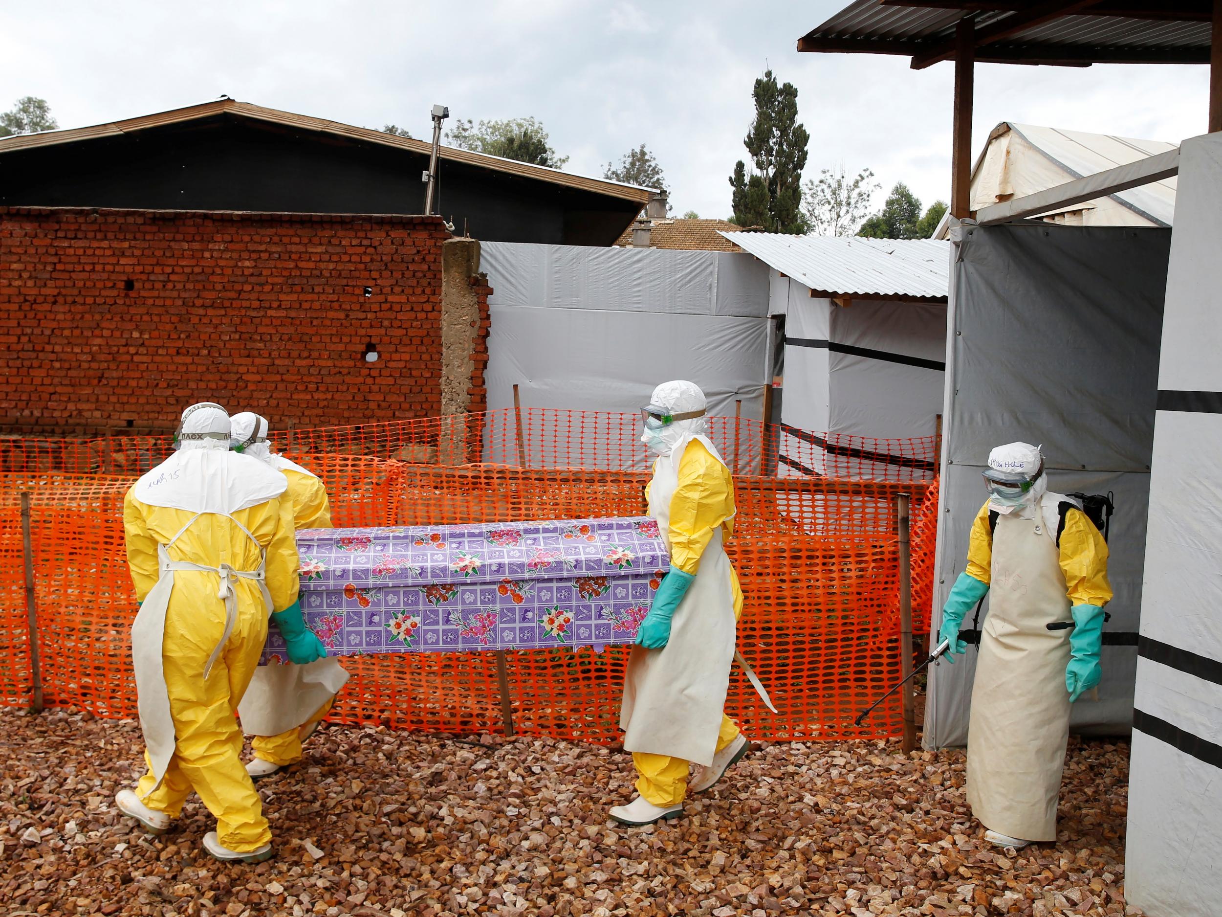 Health workers at a treatment centre in Butembo, DRC, carry the coffin of Kahambu Tulirwaho, who died of Ebola