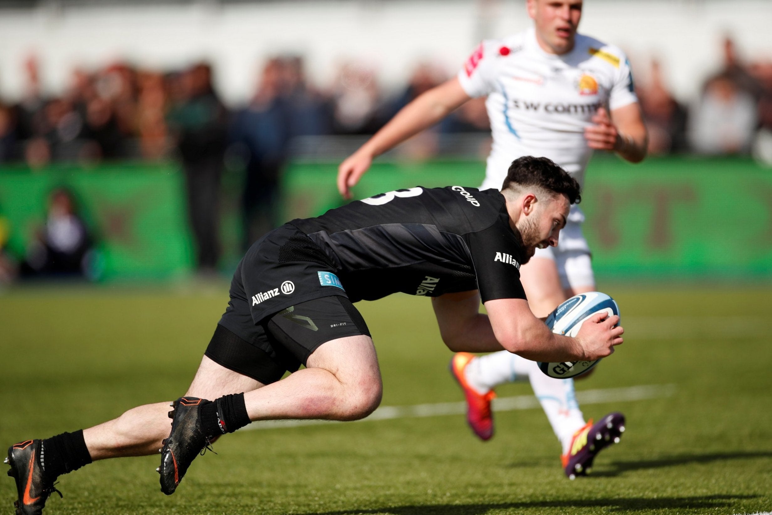 Dom Morris crosses to score a try for Saracens