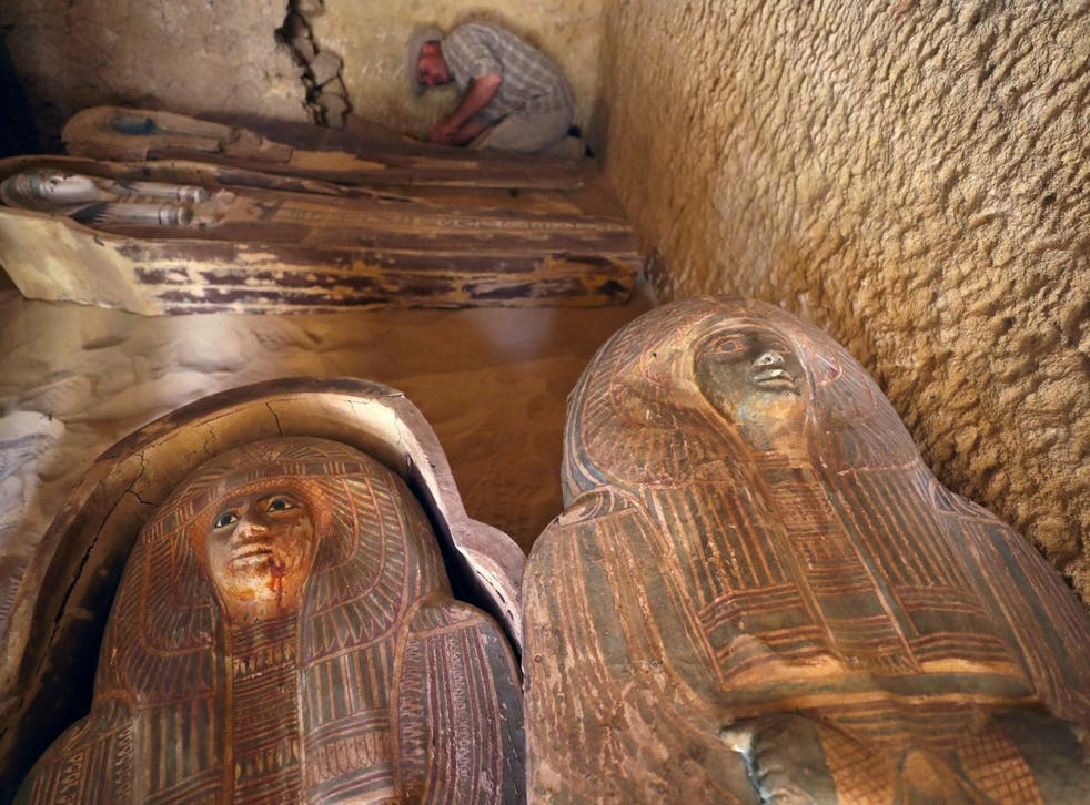 An Egyptian archaeologist works on sarcophagi at the newly discovered burial site dating back to around 2400BC