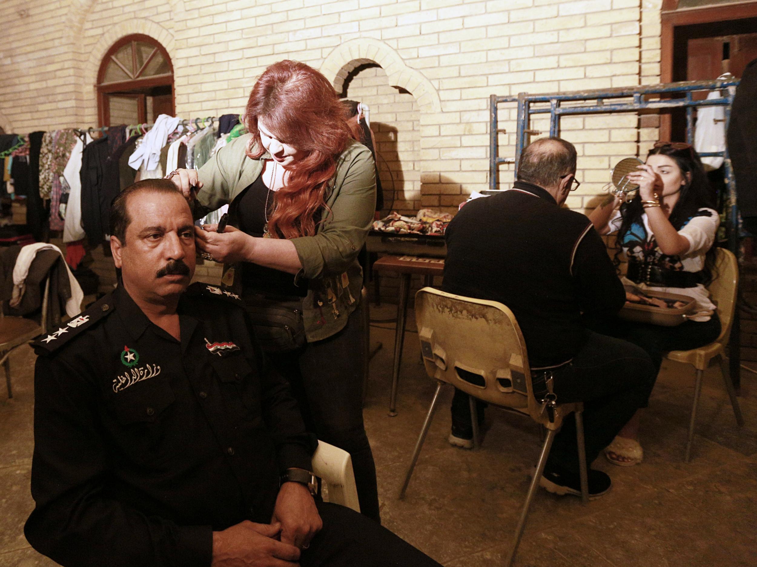 Iraqi actors prepare to perform their roles in "The Hotel," at a filming location in Baghdad, Iraq